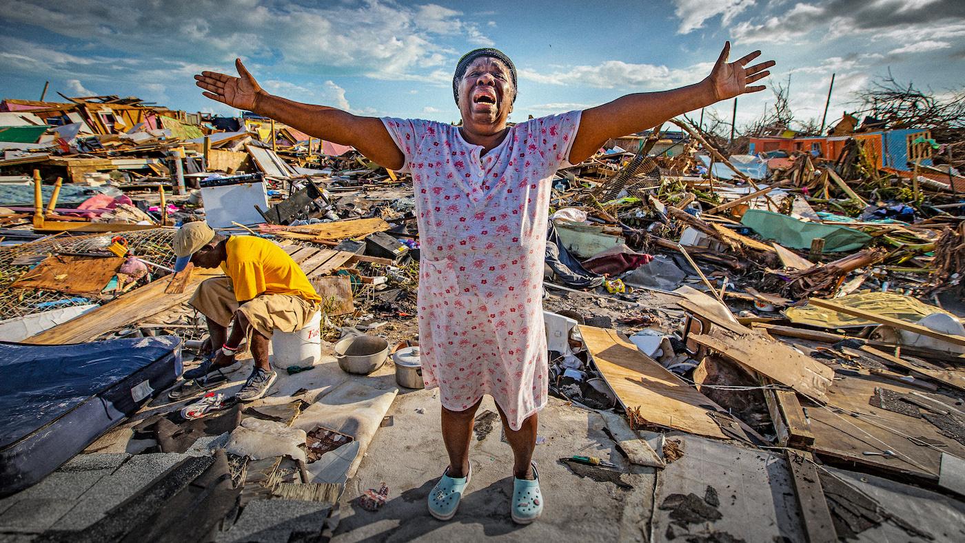 Aliana Alexis of Haiti stands on the concrete slab of what is left of her home after destruction from Hurricane Dorian in an area called "The Mud" at Marsh Harbour in Great Abaco Island, Bahamas on Thursday, September 5, 2019. Photo: Al Diaz/Miami Herald/Tribune News Service