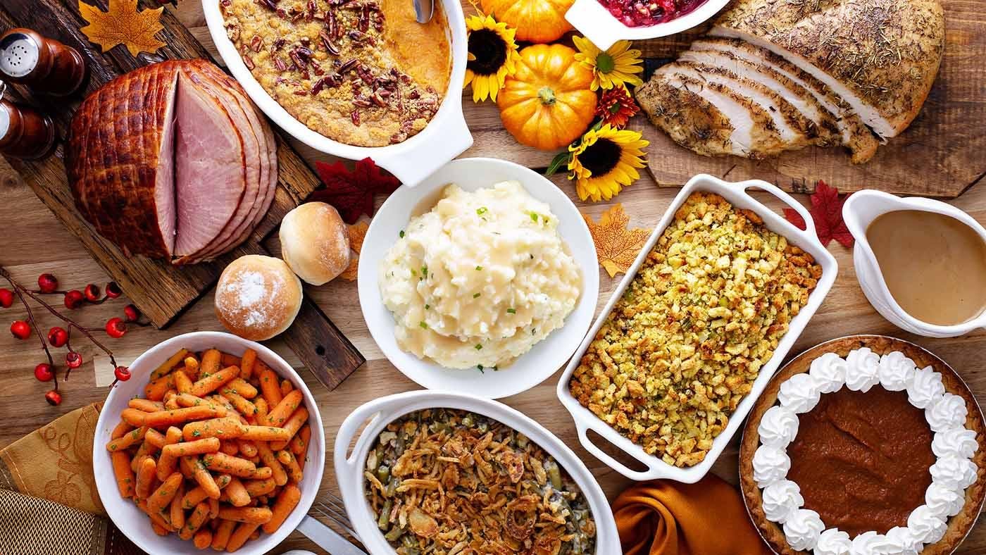 Various Thanksgiving dishes on a wooden table