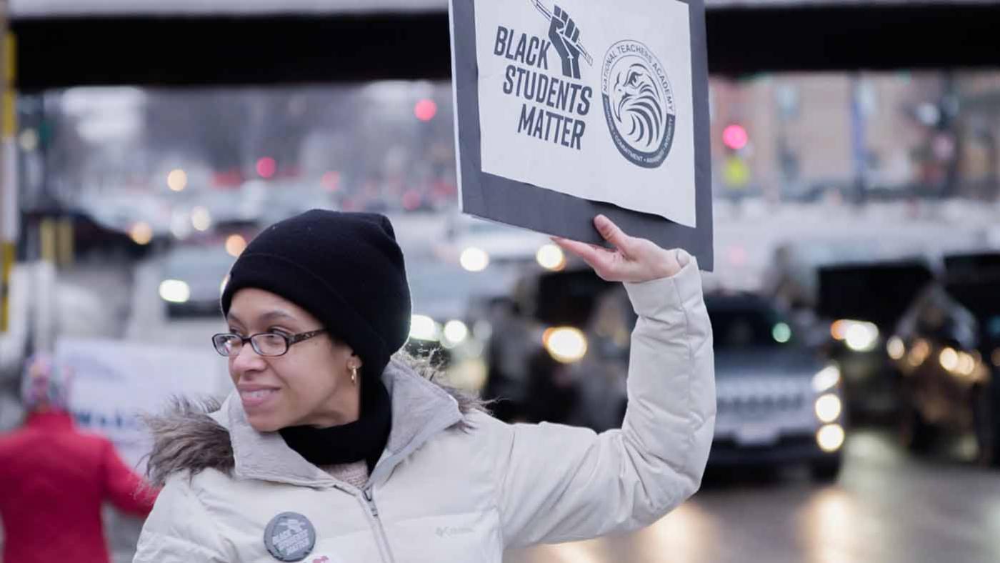 Elisabeth Greer holding a sign reading Black Students Matter