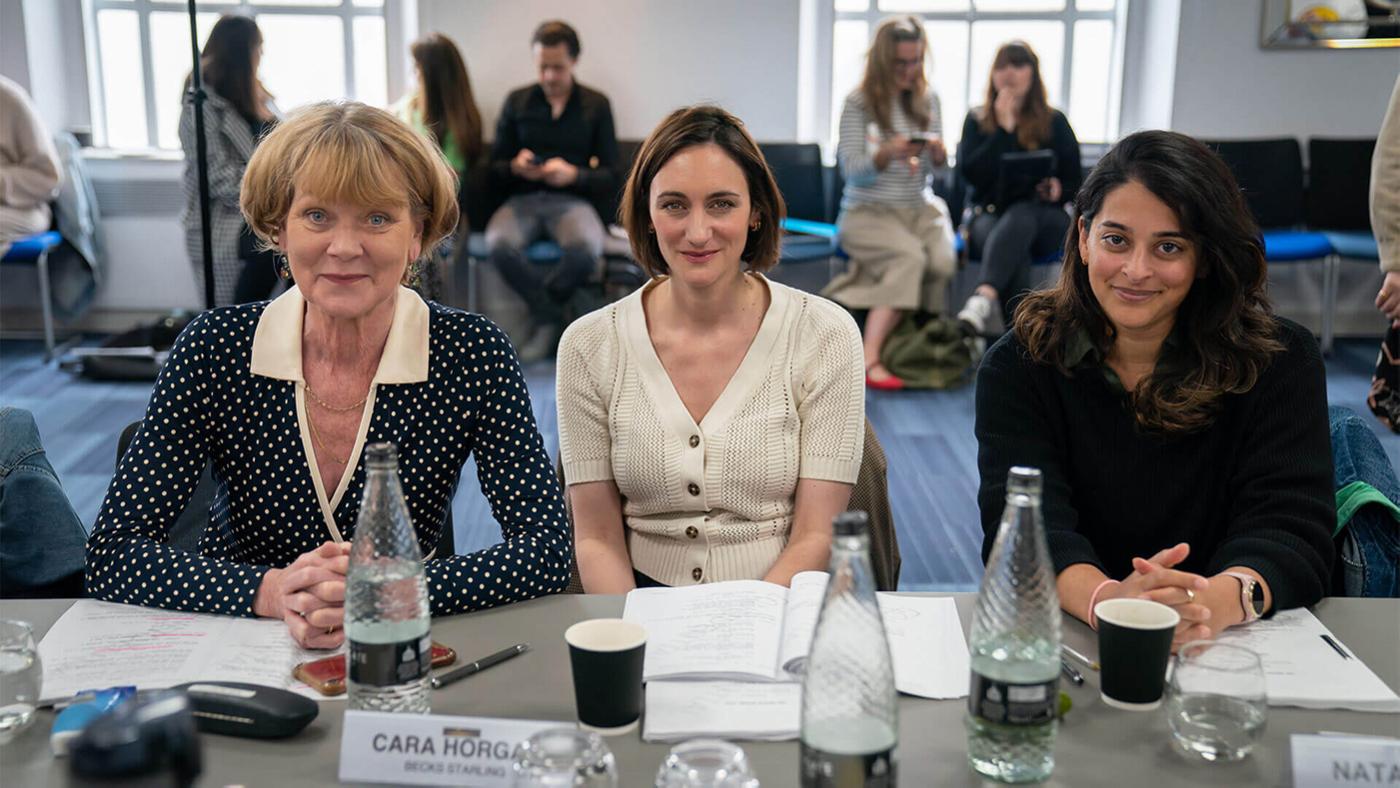 Samantha Bond, Cara Horgan, and Natalie Dew smile for a photo during a table read for The Marlow Murder Club
