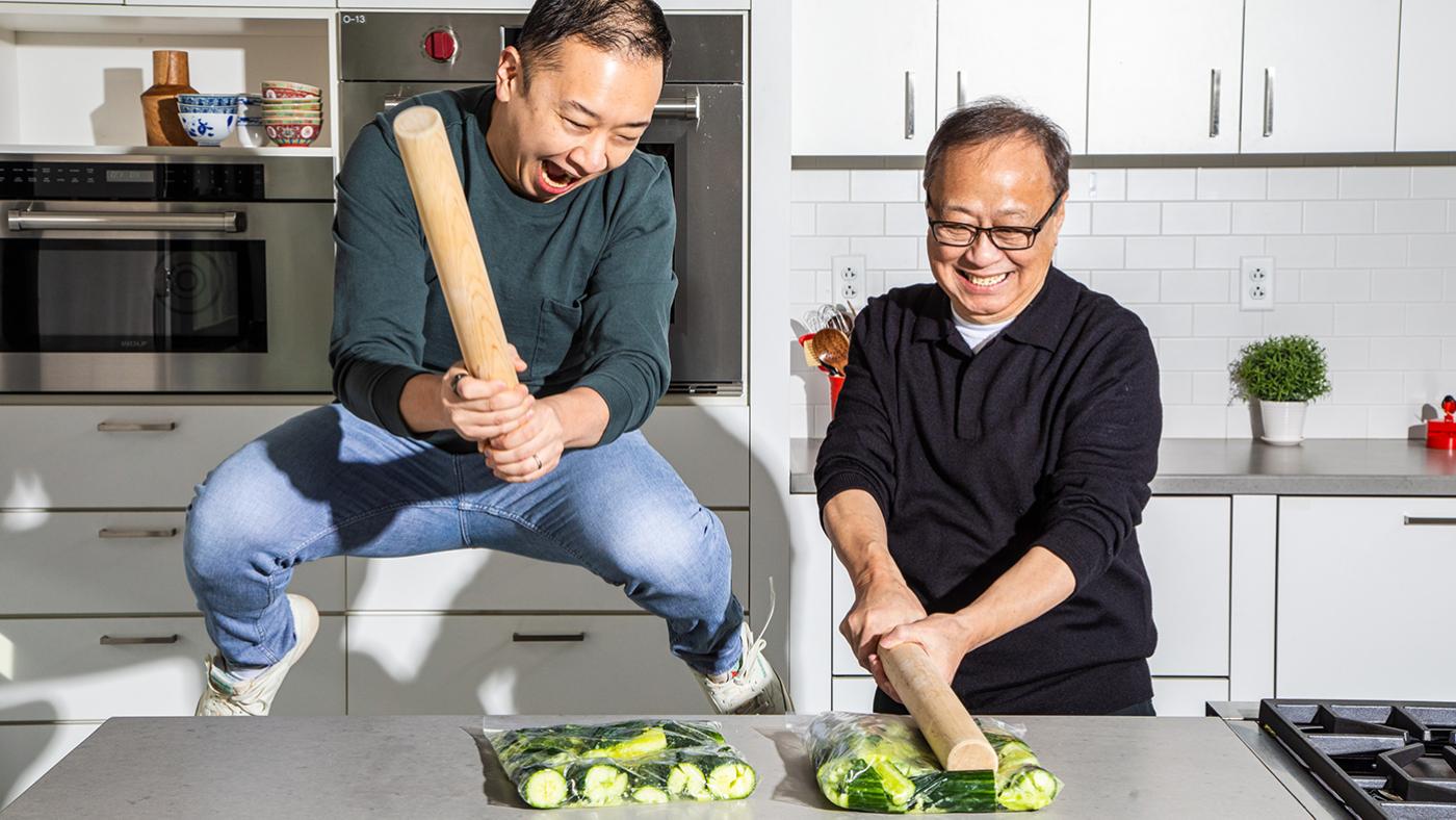 Kevin Pang and his father gleefully smash cucumbers in a kitchen