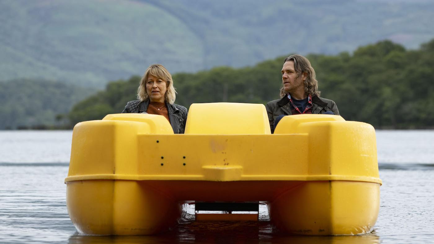 Annika and Michael on a lake in a yellow paddleboat