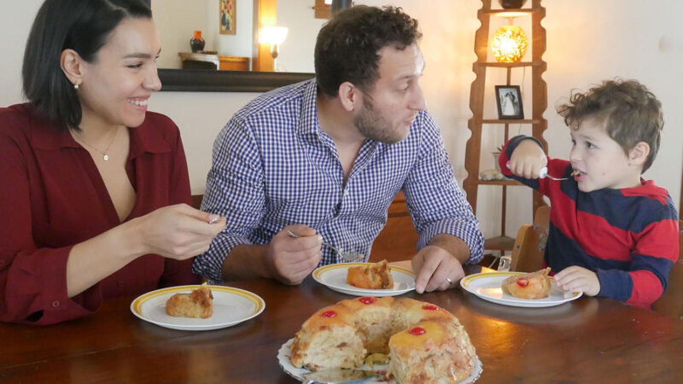A family enjoys budin de pan at the table