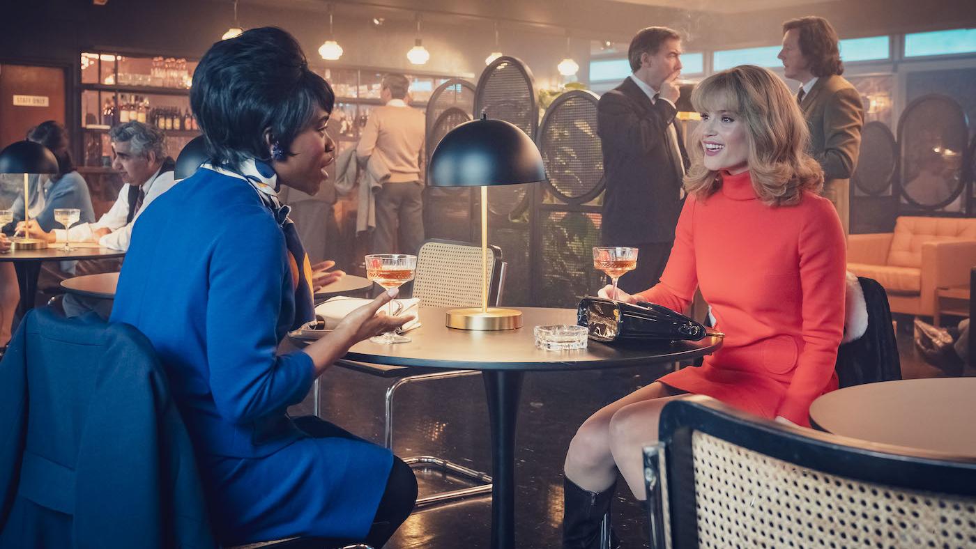 Diane and Barbara have drinks across a table from each other at a bar