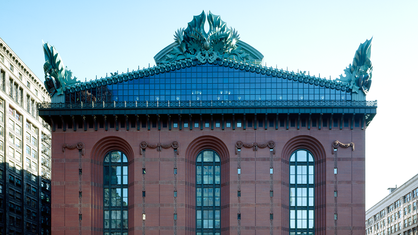 The red brick facade of the Harold Washington Library, with its glass gable and oversized ornaments