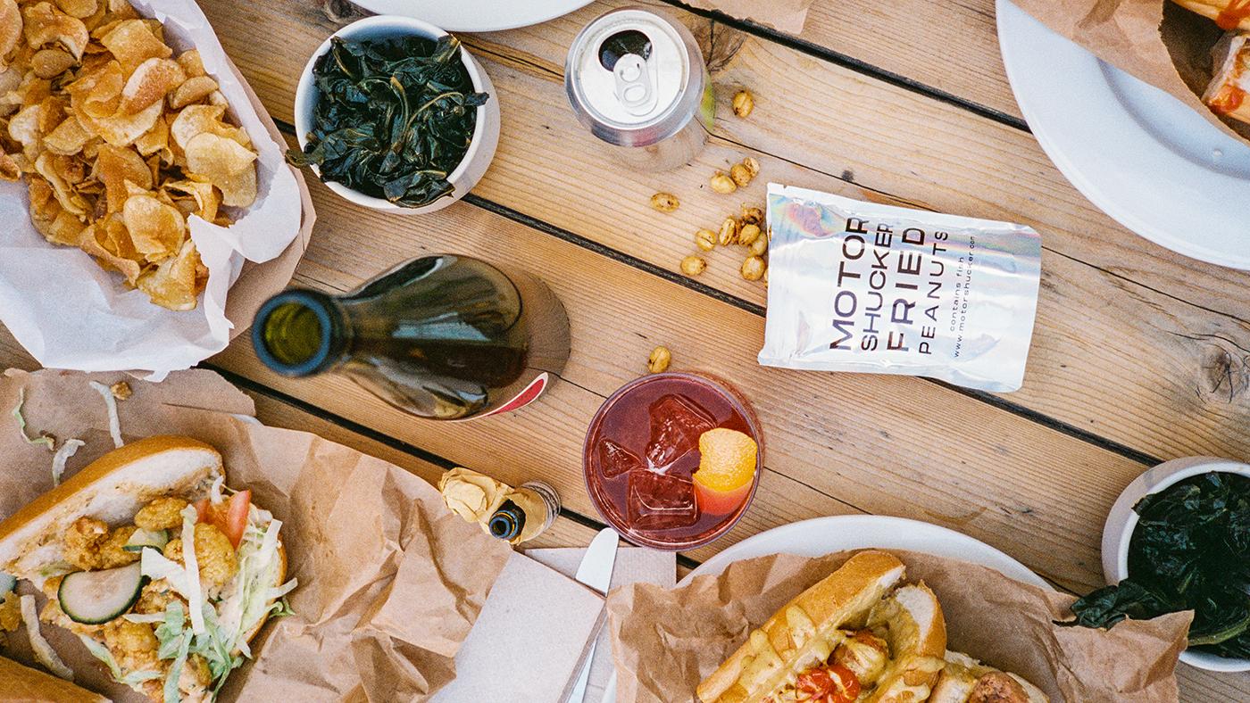 A spread of food and wine on a table seen from overhead