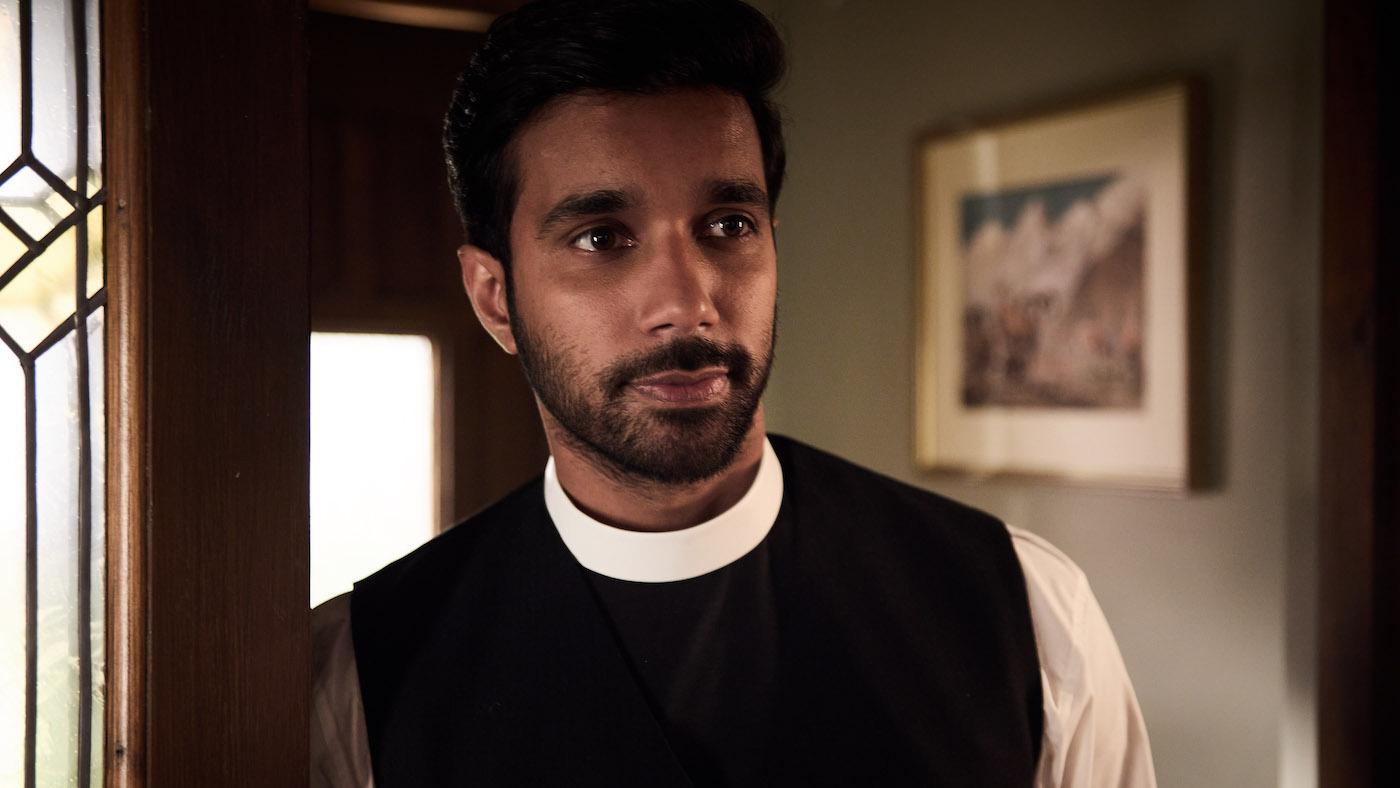 Alphy Kottaram inside in a vicar's outfit