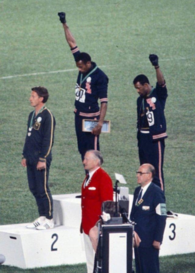 Athletes raise a fist in protest at the 1968 Olympics. Photo: Angelo Cozzi (Mondadori Publishers)