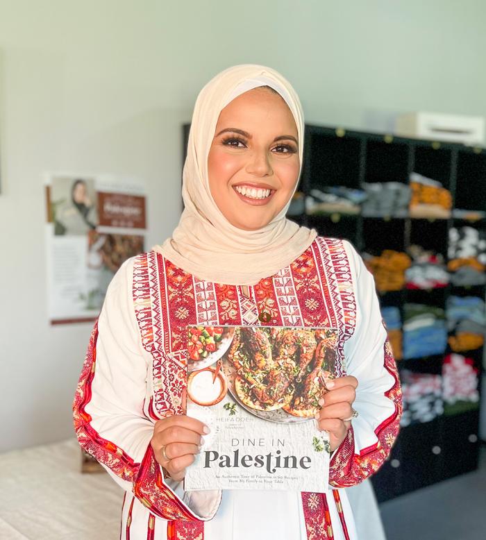 Heifa Odeh holding her cookbook, Dine in Palestine