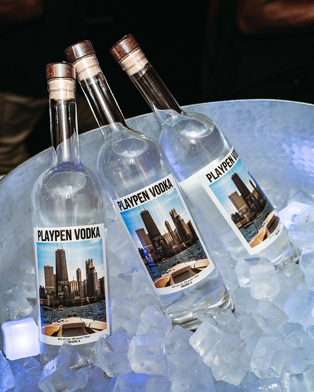 Three bottles of PlayPen Vodka in an ice bucket