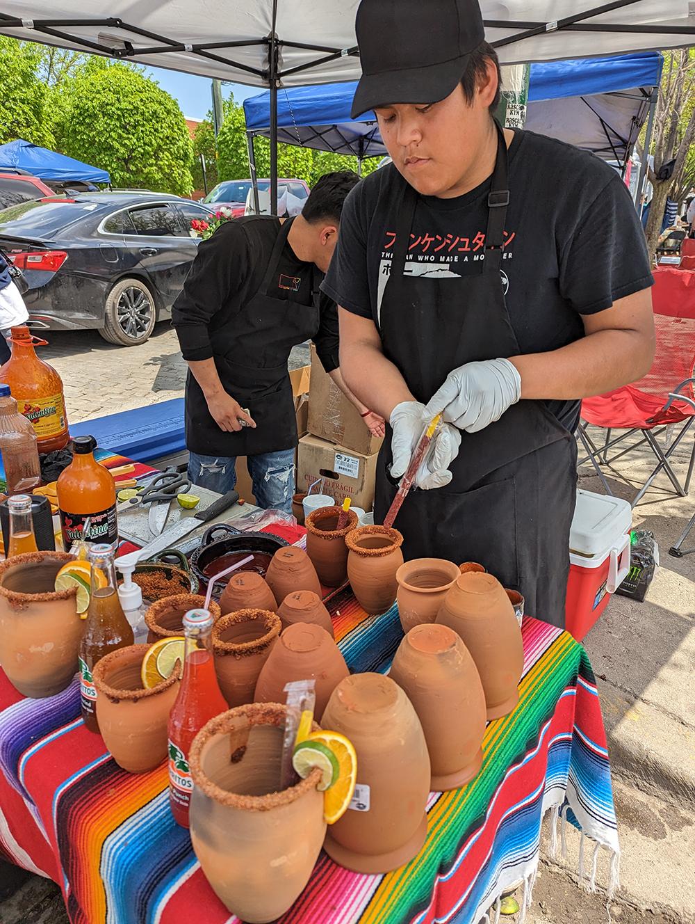 A man prepares terracotta jars for cantaritos. 
