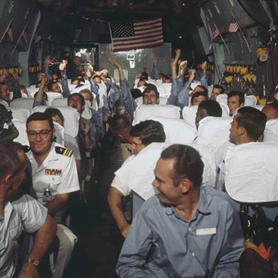 Newly released POWs rejoice on a C-141 plane during Operation Homecoming, 1973. Photo: National Archives and Records Administration